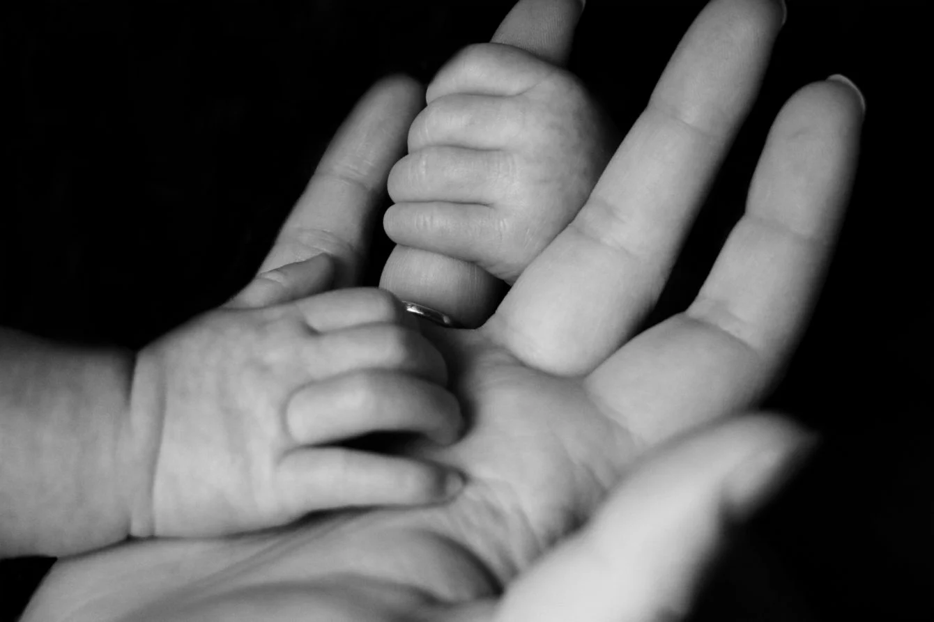 Child hand on adult hand